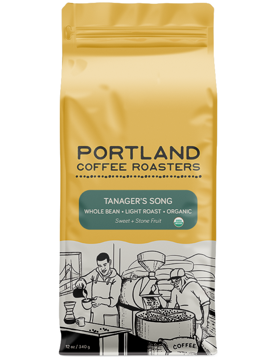 A package of Portland Coffee Roasters' Organic Tanager's Song coffee, featuring a graphic of a person roasting coffee beans. green label reads whole bean, light roast, organic, sweet, and stone fruit