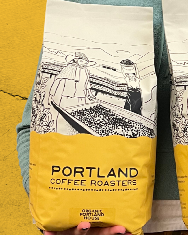 Two Portland Coffee Roasters coffee bags held against a yellow background